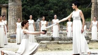 The Olympic flame is lit in a ceremony in Greece by actresses dressed in white robes.