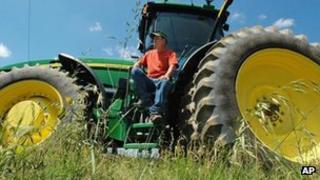 Farmer sits on tractor