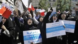 Iranian women chant slogans during a demonstration in Tehran to denounce efforts by Bahrain's Sunni rulers to forge closer ties with Saudi Arabia