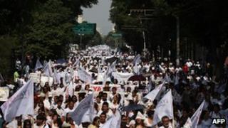 Demonstrators dressed in white march in Guadalajara
