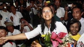 Nilar Thein, centre, an activist of the 88 Generation Students Group, shakes hands with one of her colleagues as she arrives at Rangoon airport after being released from Theyet prison Friday 13 January, 2012.