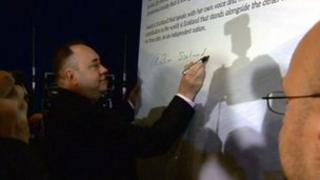 Alex Salmond signs the declaration