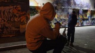 Anonymous young people in hoods