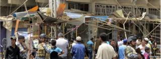 Iraqi policemen near the site of a bomb attack in Baghdad's Shula district on 31 May
