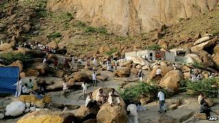 Sudanese men sit on granite rocks in the centre of the eastern Sudanese town of Kassala on February 17, 2010.