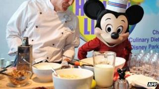Mickey Mouse and a chef prepare food in Washington. Photo: 5 June 2012
