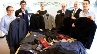Alex Ogilvie, Dan Allman, Rebecca Stannard, Peter Murley, Ian Murphy and Matthew Morel of Hawksford with a selection of the donated suits
