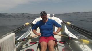 Charlie Martell aboard Blossom, the boat in which he attempted to row across the Pacific Ocean