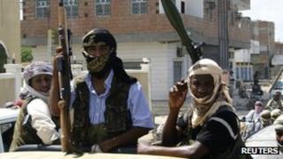 Members of Ansar al-Sharia, an al Qaeda-affiliated group, carry their weapons as they ride on a truck in the southern Yemeni town of Jaar April 28 2012