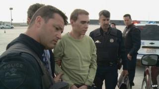 Luka Magnotta escorted off a military plane near Montreal, Canada 18 June 2012