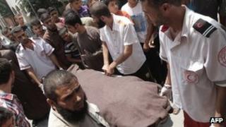Medics move the body of Ghalib Armilat in Rafah (20 June 2012)