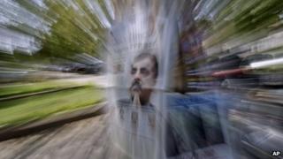 A local newspaper featuring a photo of Pakistani Prime Minister Yousuf Raza Gilani on the front page, is displayed on a tree for sale by a vendor, not pictured, in Islamabad, Pakistan, Wednesday, June 20, 2012.