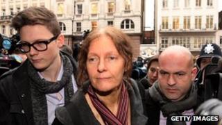 Christine Assange flanked by supporters
