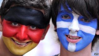 A German and a Greek fan pose in Gdansk on June 22, 2012 prior to the quarter-final match between Greece and Germany during the Euro 2012 football championships