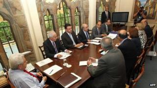 Cypriot President Demetris Christofias (left) presides over a meeting of party leaders in Nicosia, 26 June