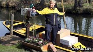 Deutsche post employee delivers mail by boat in Spreewald