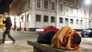 A homeless man sleeps on a cement bench in the downtown of Valparaiso, about 121 km (75 miles) northwest of Santiago, 7 July 2012.