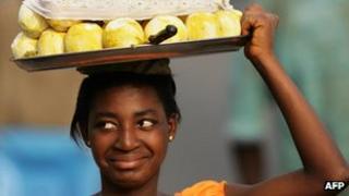 Girl carrying fruit on her head