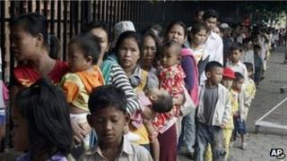 Cambodian villagers and their children outside hospital