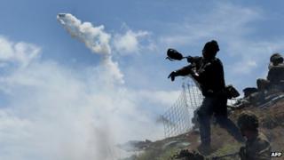 A Colombian soldier wears a gas mask at Cerro Berlin in Cauca province