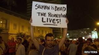 An Israeli activist holds placard during a rally in memory of Moshe Silman in Tel Aviv on 21 July