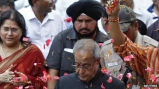 Supporters throw petals on Pranab Mukherjee in Delhi on 22 July 2012