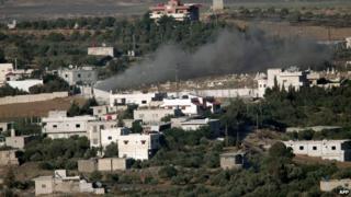 Smoke rising from the Syrian village of Jebata al-Khashab on 19 July as seen from Buqaata in the Israeli-occupied Golan Heights.