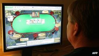 File picture showing a man playing poker on his computer connected to an internet gaming site from his home in Manassas, Virginia 2 October 2006