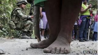 Members of an indigenous group and a soldier in Cauca province