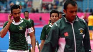 Sohail Abbas (L) of Pakistan leaves the field along with team members after Pakistan lost to Australia