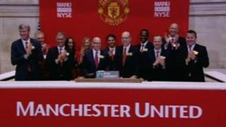 Manchester United executives ring the opening bell at the New York Stock Exchange
