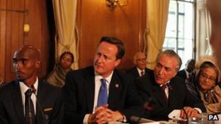 British athlete Mo Farah, Prime Minister David Cameron and Brazil's vice-president Michael Terner at the summit in London