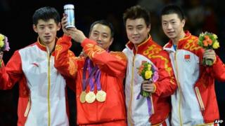 China's gold medallist team Zhang Jike, coach Liu Guoliang, Wang Hao and Ma Long pose after the podium of the table tennis men's team at the London Olympic Games, 08 Aug 2012