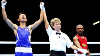 Satoshi Shimizu of Japan (L) celebrates victory over Isaac Dogboe of Ghana during their Men's Bantam Weight (56kg) bout on Day 1 of the London 2012 Olympic Games