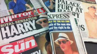 Papers with the story about Prince Harry on the front.