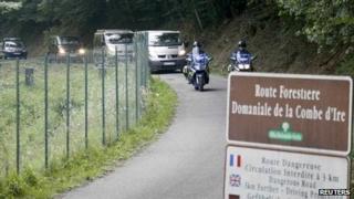 Police vehicles leave the scene of the crime