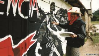 Banksy painting a mural