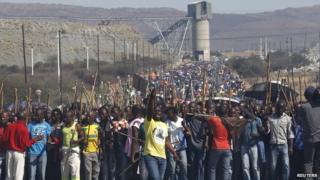 Mine workers take part in a march at Lonmin's Marikana mine in South Africa's North West Province on 10 September 2012