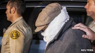 Nakoula Basseley Nakoula leaves his house under police guard