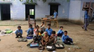 Indian school children read in an open air classroom at a government school in Bagpath district in Uttar Pradesh.