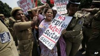 Police arrest an activist of SUCI as she shouts slogans against the government during a protest against economic reforms in the eastern Indian city of Bhubaneswar, India, Thursday, Sept. 27, 2012.