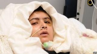 Malala Yousafzai lying in her bed after receiving treatment at the Queen Elizabeth Hospital/University Hospitals in Birmingham