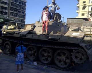 Children play on an old Gaddafi tank in Misrata