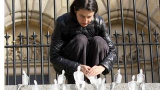 One of the volunteers places a small ice figure on the steps of Custom House Square in Belfast