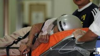 An arson suspect is escorted on a bed by police at Hsuea Chia police station in Tainan in southern Taiwan, on 23 October, 2012