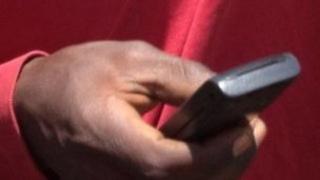 Kenyan man texting