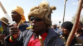 Striking miners chant slogans as they gather at the AngloGold Ashanti mine in Carletonville, north-west of Johannesburg, 25 October