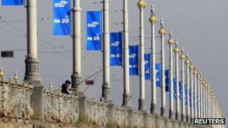 A man fishes beneath election posters of the ruling Ukrainian Party of Regions on the Patona bridge over the Dnieper River in downtown Kiev October 22
