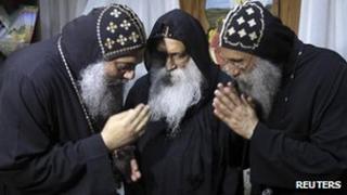 Papal candidates Fr Pachomius (L), Fr Raphael (C) and Fr Seraphim (R) talk in Cairo, 22 October 2012