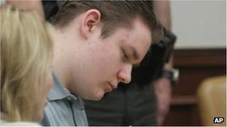 Brogan Rafferty takes notes during morning proceedings in the courtroom at the Summit County Common Pleas Court in Akron Ohio 25 October 2012